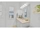 Clean bathroom with a single vanity, large mirror, and neutral color palette at 5035 Kiva Cir, Bradenton, FL 34211