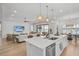 Open concept kitchen with large island and breakfast bar overlooking the living room and lake at 5035 Kiva Cir, Bradenton, FL 34211