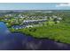 Aerial view of waterfront community with tennis court and boat slips at 515 Leffingwell Ave # 109, Ellenton, FL 34222