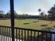 Screened balcony overlooks a lush green backyard with palm trees at 515 Leffingwell Ave # 109, Ellenton, FL 34222