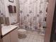 Bathroom with double vanity and seashell-themed shower curtain at 515 Leffingwell Ave # 109, Ellenton, FL 34222