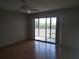 Bright bedroom with wood floors and sliding glass door leading to a balcony at 515 Leffingwell Ave # 109, Ellenton, FL 34222