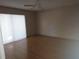 Bedroom with wood floors and sliding glass door with blinds at 515 Leffingwell Ave # 109, Ellenton, FL 34222