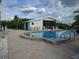 Community pool with lounge chairs and cabana at 515 Leffingwell Ave # 109, Ellenton, FL 34222