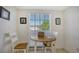 Small dining area with round table and chairs, near a window at 5242 Wedgewood Ln # 62, Sarasota, FL 34235