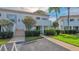 Exterior view of condo building with landscaping and walkway at 5242 Wedgewood Ln # 62, Sarasota, FL 34235