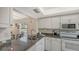 Bright kitchen with white cabinets, granite counters, and stainless steel appliances at 5242 Wedgewood Ln # 62, Sarasota, FL 34235