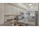 Kitchen with white cabinets, granite countertops and stainless steel appliances at 5242 Wedgewood Ln # 62, Sarasota, FL 34235
