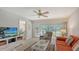 Living room with comfortable seating and access to balcony at 5242 Wedgewood Ln # 62, Sarasota, FL 34235