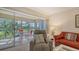 Living room with comfortable seating and view of the balcony at 5242 Wedgewood Ln # 62, Sarasota, FL 34235