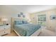 Main bedroom with king-size bed and coastal decor at 5242 Wedgewood Ln # 62, Sarasota, FL 34235