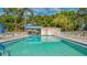 Inviting community pool with lounge chairs and shaded areas at 5242 Wedgewood Ln # 62, Sarasota, FL 34235