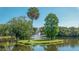 Serene community lake with lush landscaping and a central fountain at 5242 Wedgewood Ln # 62, Sarasota, FL 34235