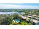 Aerial view of Spring Lakes community, featuring a lake, lush landscaping, and a pool at 527 Spring Lakes Blvd, Bradenton, FL 34210
