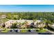 Aerial view of condo building, showing parking and surrounding trees at 527 Spring Lakes Blvd, Bradenton, FL 34210