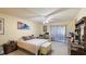Spacious bedroom with large bed, dresser, and access to balcony at 527 Spring Lakes Blvd, Bradenton, FL 34210