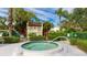 Community hot tub area with surrounding landscaping and seating at 527 Spring Lakes Blvd, Bradenton, FL 34210