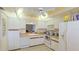 White kitchen with wood countertops and appliances at 527 Spring Lakes Blvd, Bradenton, FL 34210