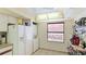 Galley kitchen with stacked washer and dryer at 527 Spring Lakes Blvd, Bradenton, FL 34210