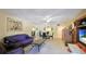 Living room with purple sofa and entertainment center at 527 Spring Lakes Blvd, Bradenton, FL 34210