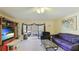 Living area with purple sofa and built-in shelving at 527 Spring Lakes Blvd, Bradenton, FL 34210