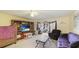Living room with purple sofa and access to patio at 527 Spring Lakes Blvd, Bradenton, FL 34210