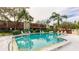 Inviting community pool surrounded by lush landscaping and lounge chairs at 527 Spring Lakes Blvd, Bradenton, FL 34210