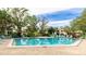 Community pool and spa with plenty of lounge chairs, perfect for relaxation at 527 Spring Lakes Blvd, Bradenton, FL 34210