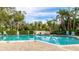 Relaxing community pool with plenty of lounge chairs and a brick patio area at 527 Spring Lakes Blvd, Bradenton, FL 34210