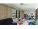 Sunroom with pool view and ample space for relaxation and play at 527 Spring Lakes Blvd, Bradenton, FL 34210