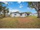 Large backyard with grassy area and partial home view at 530 Saint Andrews Dr, Sarasota, FL 34243
