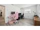 Bright bedroom with a pink desk setup and hardwood floors at 530 Saint Andrews Dr, Sarasota, FL 34243