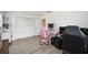 Bedroom with black and pink gaming chairs and hardwood floors at 530 Saint Andrews Dr, Sarasota, FL 34243