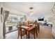 Spacious dining room with wooden table, seating for six and access to patio at 530 Saint Andrews Dr, Sarasota, FL 34243