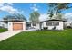 Updated ranch home with modern garage door, fresh landscaping, and spacious yard at 530 Saint Andrews Dr, Sarasota, FL 34243