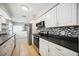 Modern kitchen with stainless steel appliances and black countertops at 530 Saint Andrews Dr, Sarasota, FL 34243