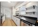 Modern kitchen with stainless steel appliances and stylish floating shelves at 530 Saint Andrews Dr, Sarasota, FL 34243