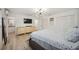 Main bedroom with king bed, dresser, and access to bathroom at 530 Saint Andrews Dr, Sarasota, FL 34243