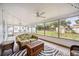 Sunroom with tiled floor, wicker furniture, and backyard view at 530 Saint Andrews Dr, Sarasota, FL 34243