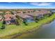 Aerial view of houses near a lake, showcasing pools and lush landscaping at 5341 Popoli Way, Sarasota, FL 34238