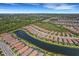 Aerial view of a waterfront community, highlighting a specific house among others at 5341 Popoli Way, Sarasota, FL 34238