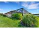 Landscaped backyard with screened patio and lush greenery at 5341 Popoli Way, Sarasota, FL 34238