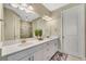 Elegant bathroom with double vanity and a large mirror at 5341 Popoli Way, Sarasota, FL 34238