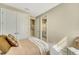 Bright bedroom with ensuite bathroom and comfortable bedding at 5341 Popoli Way, Sarasota, FL 34238