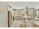 Modern kitchen with white cabinets and a sink at 5341 Popoli Way, Sarasota, FL 34238