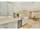 Modern kitchen with white cabinets, stainless steel appliances, and an island at 5341 Popoli Way, Sarasota, FL 34238
