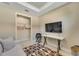 Relaxing living room with TV and adjacent office space at 5341 Popoli Way, Sarasota, FL 34238