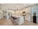 Modern kitchen with white cabinets, quartz countertops, and island at 5436 Hope Sound Cir, Sarasota, FL 34238