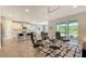 Spacious living room with leather seating and view into kitchen at 5436 Hope Sound Cir, Sarasota, FL 34238