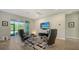 Open living space with comfy seating and sliding glass doors at 5436 Hope Sound Cir, Sarasota, FL 34238